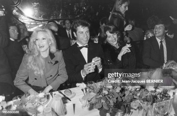 John Travolta en compagnie de Sylvie Vartan, Charlotte Rampling et Patrick Sabatier lors d'un diner donné en son honneur chez Maxim's le 26 septembre...