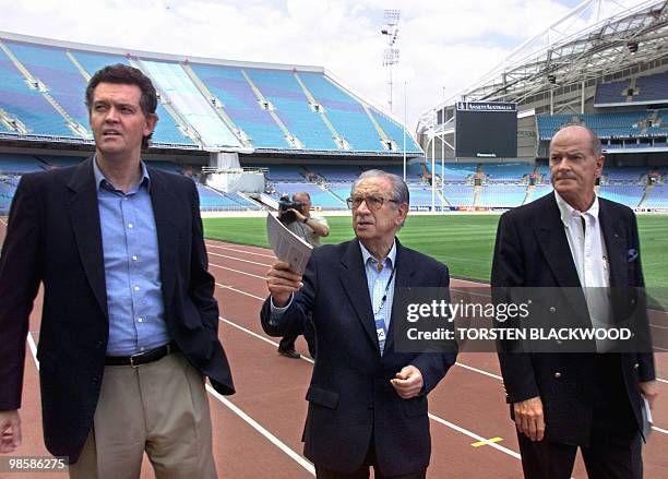 International Olympic Committee President Juan Antonio Samaranch , IOC Vice-President Kevin Gosper and Olympics Minister Michael Knight inspect...