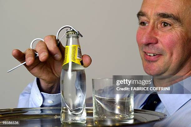 Belgium's Alexis Babusiaux poses with his invention, an original bottle-opener that require only one hand to open a bottle, during the opening day of...