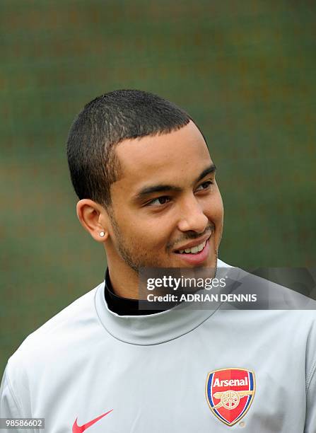 Arsenal's forward Theo Walcott walks onto the pitch for a training session at the club's complex in London Colney on April 5, 2010. Arsenal travels...