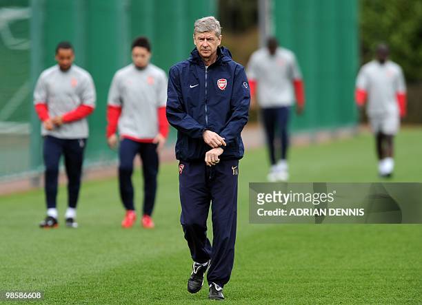Arsenal's French coach Arsene Wenger walks onto the pitch for a training session at the club's complex in London Colney on April 5, 2010. Arsenal...