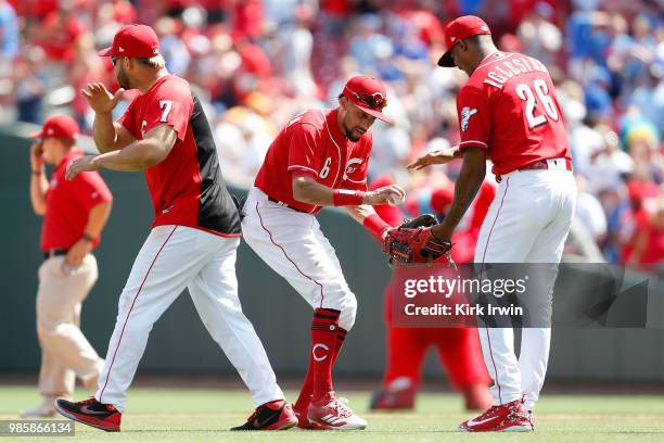 Billy Hamilton of the Cincinnati Reds congratulates Raisel Iglesias after defeating the Chicago Cubs 8-6 at Great American Ball Park on June 24, 2018...