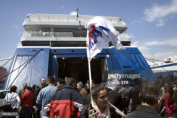 Greek unionists representing Communist workers block the entrance to ferries on April 21, 2010 in Athens, to prevent their departure in the port of...