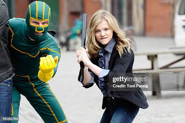 Actress Chloe Moretz with superhero character attend the photocall of 'Kick-Ass' at Kulturbrauerei on March 30, 2010 in Berlin, Germany.