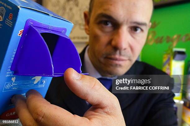 Spain's Luis Burgos Agudo poses with his invention, a universal opening device for packed solid food and powders during the opening day of the 38th...