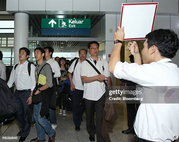 Passengers from Malaysia Airlines flight MH001s arrive after travelling from Frankfurt, at Kuala Lumpur International Airport, in Kuala Lumpur,...