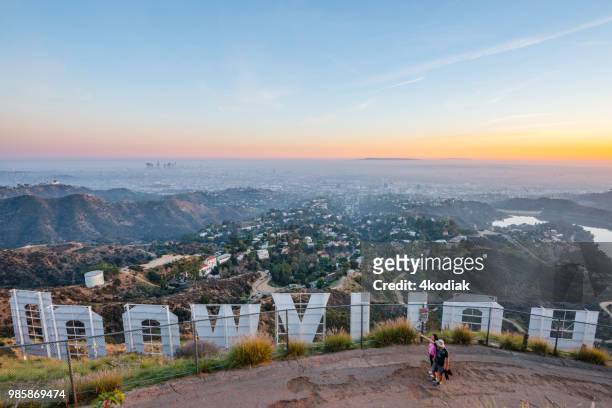 hollywood sign and los angeles with hikers - mulholland drive stock pictures, royalty-free photos & images