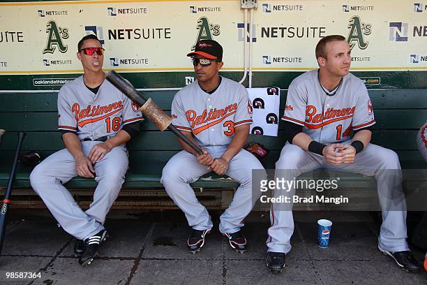 Lou Montanez , Cesar Izturis, and Nolan Reimold of the Baltimore Orioles get ready in the dugout before the game between the Baltimore Orioles and...