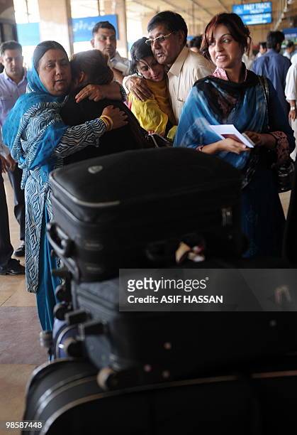 Relatives share emotions with passengers of a London-bound state-run Pakistan International Airlines before entering the departure hall at Karachi...