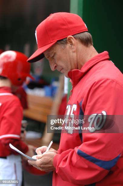 Jim Riggleman, manager of the Washington Nationals, reviews lineup card during a baseball game against the Milwaukee Brewers on April 18, 2010 at...