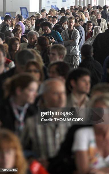 Passengers queue and wait inside the Roissy Charles de Gaulle Airport outside Paris, on April 16, 2010. French aviation authorities ordered airports...