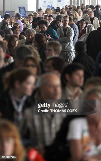 Passengers queue and wait inside the Roissy Charles de Gaulle Airport outside Paris, on April 16, 2010. French aviation authorities ordered airports...