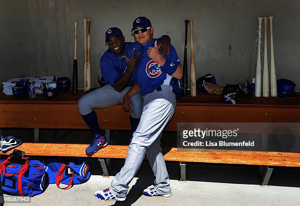 Alfonso Soriano and teammate Kosuke Fukudome of the Chicago Cubs in the dugout before a Spring Training game against the Chicago White Sox on March...