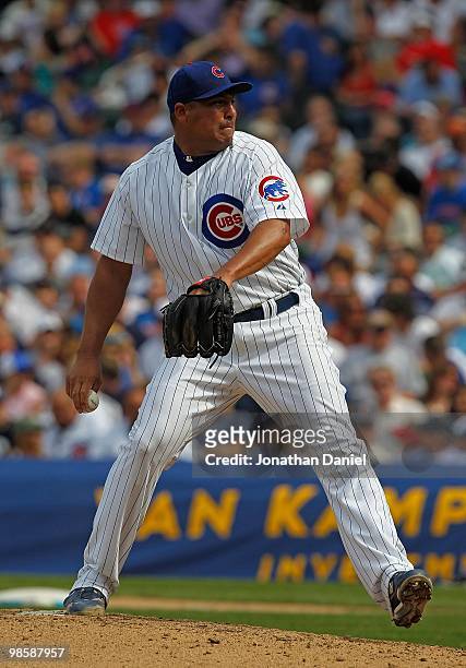 Starting pitcher Carlos Zambrano of the Chicago Cubs, wearing a number 42 jersey in honor of Jackie Robinson, delivers the ball against the Milwaukee...