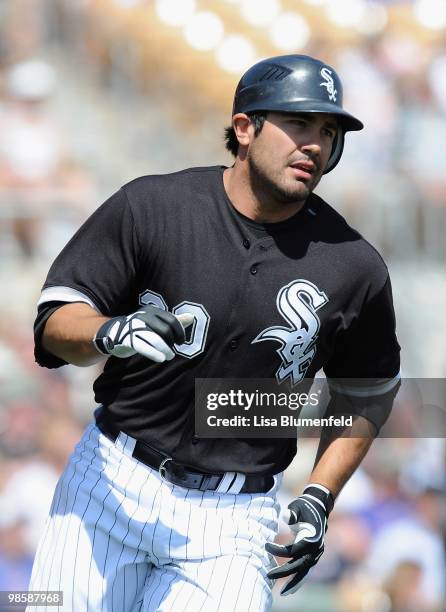 Carlos Quentin of the Chicago White Sox runs to first base during a Spring Training game against the Chicago Cubs on March 19, 2010 at The Ballpark...