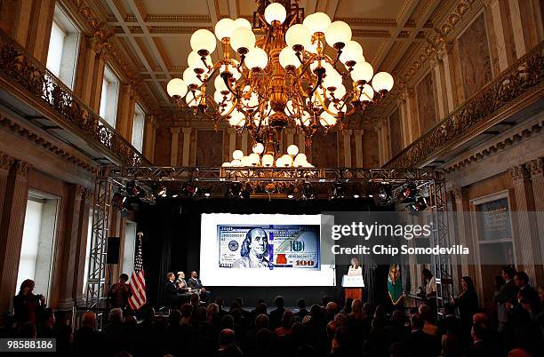 An image of the newly designed $100 note is displayed on a large television screen in the Cash Room at the Treasury Department April 21, 2010 in...