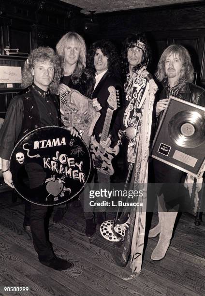 American rock band Aerosmith host a party for Les Paul celebrating his 75th birthday on June 12, 1990 at The Hard Rock Cafe in New York City, New...