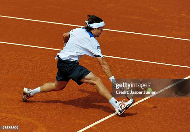 David Ferrer of Spain stretches to play a backhand to his fellow countryman Marcel Granollers on day three of the ATP 500 World Tour Barcelona Open...