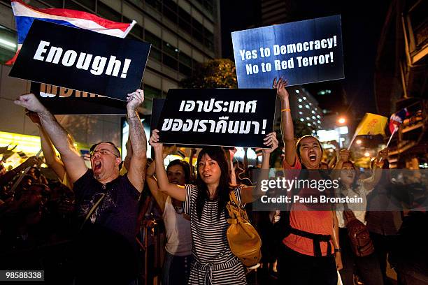 Pro- Government supporters chant slogans directed at red-shirts as tensions rise between the two opposing sides, during the red-shirts campaign to...