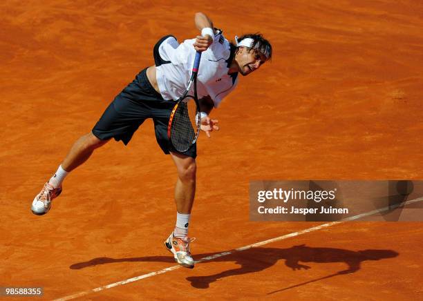 David Ferrer of Spain serves the ball to his fellow countryman Marcel Granollers on day three of the ATP 500 World Tour Barcelona Open Banco Sabadell...