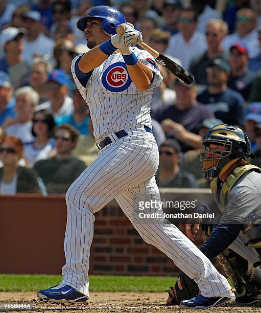 Geovany Soto of the Chicago Cubs, wearing a number 42 jersey in honor of Jackie Robinson, hits the ball against the Milwaukee Brewers at Wrigley...