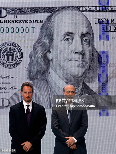 Treasury Secertary Timothy Geithner and Federal Reserve Chairman Ben Bernanke pose for photos during the unveiling of the new $100 note at the...