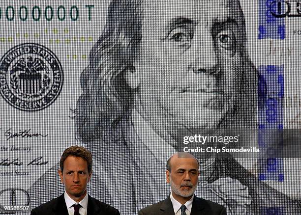 Treasury Secertary Timothy Geithner and Federal Reserve Chairman Ben Bernanke pose for photos during the unveiling of the new $100 note at the...