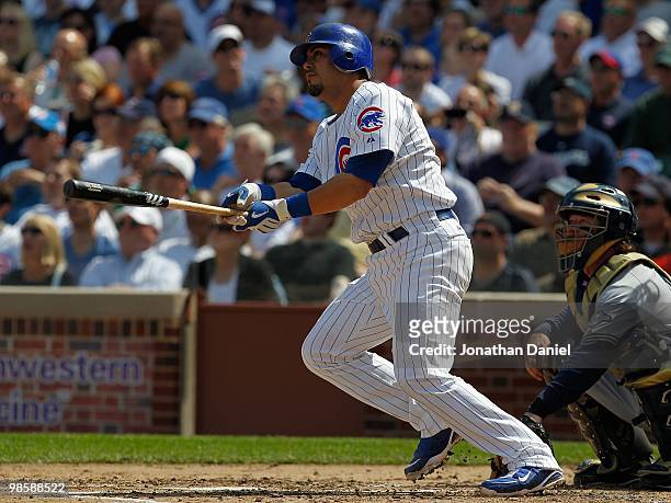 Geovany Soto of the Chicago Cubs, wearing a number 42 jersey in honor of Jackie Robinson, hits the ball against the Milwaukee Brewers at Wrigley...