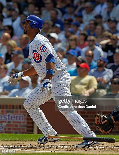 Derrek Lee of the Chicago Cubs, wearing a number 42 jersey in honor of Jackie Robinson, follows the flight of his home run ball in the 1st inning...