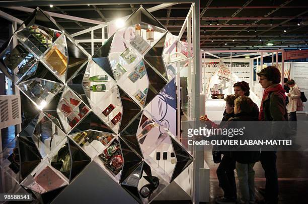 People look at counterfeit items seized by French customs and shown on April 21, 2010 during an exhibition on counterfeiting at the Cite des Sciences...