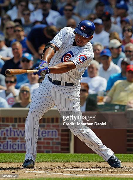 Starting pitcher Carlos Zambrano of the Chicago Cubs, wearing a number 42 jersey in honor of Jackie Robinson, swings at the ball against the...