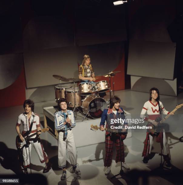 Eric Faulkner, Les McKeown, Derek Longmuir, Alan Longmuir and Stuart Wood of the Bay City Rollers perform on a BBC television show in 1975.