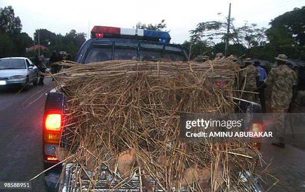 Picture taken on April 20, 2010 shows the bodies of muslim Hausa motorists carried away by a pick up truck after being exhumed by soldiers hours...
