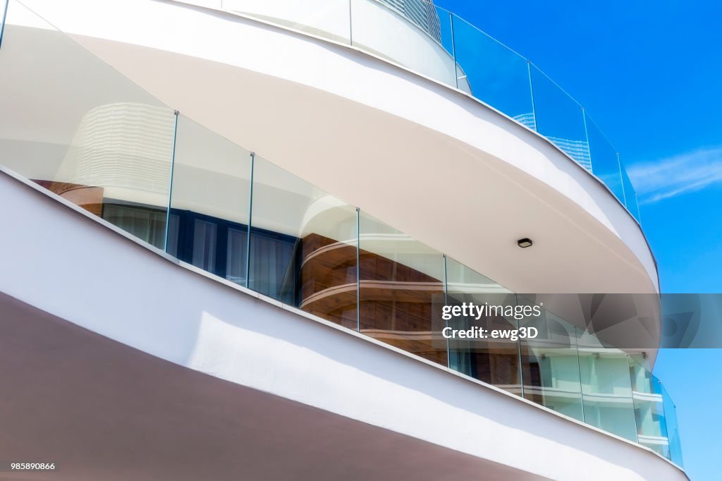 Modern architecture with large white balconies in modern white apartment building