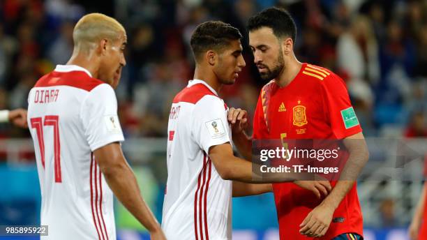 Achraf Hakimi of Morocco speaks with Sergio Busquets of Spain during the 2018 FIFA World Cup Russia group B match between Spain and Morocco at...