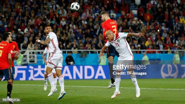 Gerard Pique of Spain and Nabil Dirar of Morocco battle for the ball during the 2018 FIFA World Cup Russia group B match between Spain and Morocco at...