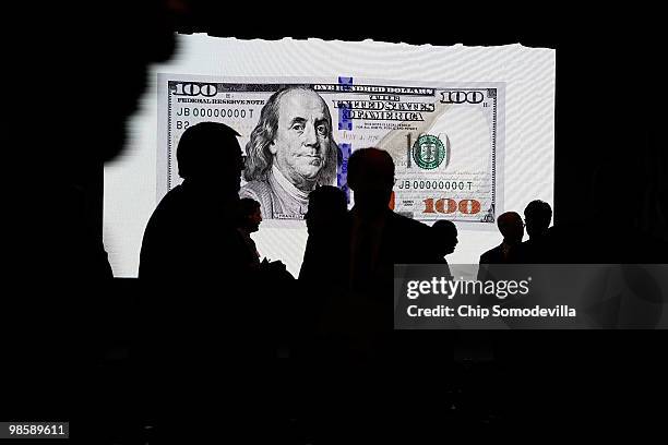 Journalists and government officials attend the unveiling of the new $100 note at the Treasury Department April 21, 2010 in Washington, DC. According...