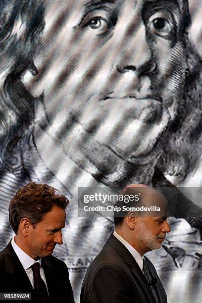 Treasury Secretary Timothy Geithner and Federal Reserve Chairman Ben Bernanke pose for photographs during the unveiling of the new $100 note at the...