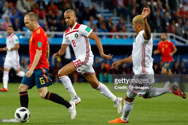 Andres Iniesta of Spain and Karim El Ahmadi of Morocco battle for the ball during the 2018 FIFA World Cup Russia group B match between Spain and...