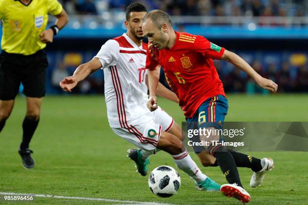Younes Belhanda of Morocco and Andres Iniesta of Spain battle for the ball during the 2018 FIFA World Cup Russia group B match between Spain and...