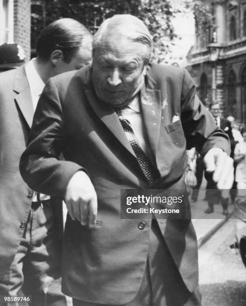 The new British Prime Minister Edward Heath is splattered with red paint as he returns to Downing Street after lunch at the St James' Club, 20th June...