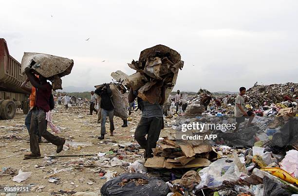 Rag pickers collect recyclable items at the Duquesa dump, in Santo Domingo, on April 21, 2010. It is estimated that some 1500 scavengers - 90 percent...