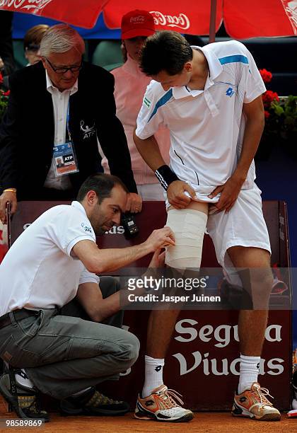 Sergiy Stakhovsky of the Ukraine is treated for an injury during his match against Juan Carlos Ferrero of Spain on day three of the ATP 500 World...