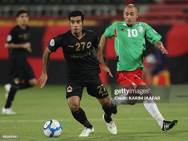 Younes Ali of Qatar's Al-Rayyan club competes with of Jordan's Al-Wihdat player Issa Husamaldin during their 2010 AFC Cup Group E football match in...