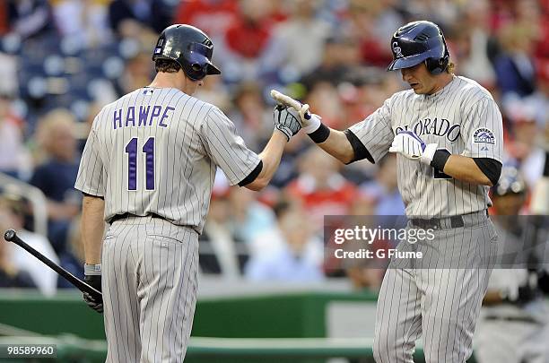 Troy Tulowitzki of the Colorado Rockies is congratulated by Brad Hawpe after hitting a home run against the Washington Nationals April 20, 2010 at...