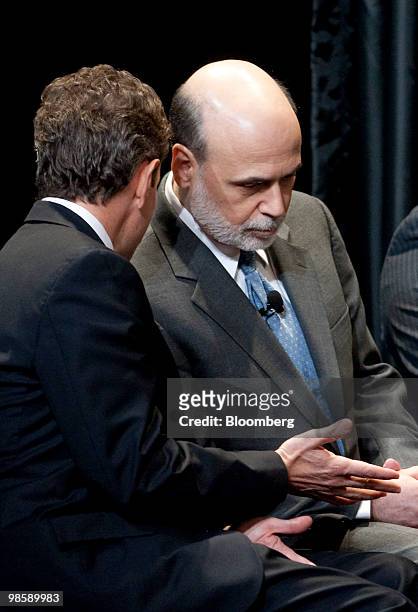 Ben S. Bernanke, chairman of the U.S. Federal Reserve, right, talks to Timothy Geithner, U.S. Treasury secretary, at the unveiling of the new $100...