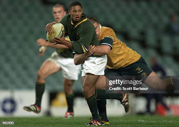 Daniel Philander of South Africa is tackled by Anthony Mathison of Australia during the U21 2001 Ricoh Southern Hemisphere Tournament between...