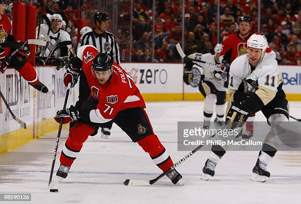 Nick Foligno of the Ottawa Senators skates with the puck while being defended by Jordan Staal of the Pittsburgh Penguins during Game 3 of the Eastern...