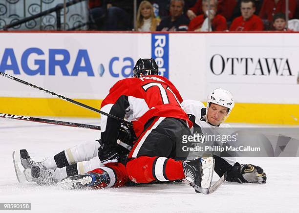 Mark Eaton of the Pittsburgh Penguins is taken down by Nick Foligno of the Ottawa Senators during Game 3 of the Eastern Conference Quaterfinals...