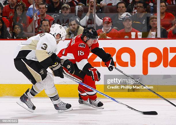 Jesse Winchester of the Ottawa Senators skates with the puck while being pressured by Alex Goligoski of the Pittsburgh Penguins defends during Game 3...